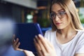 Focused woman using a tablet in the office