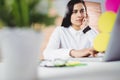 Focused woman working on laptop in office Royalty Free Stock Photo