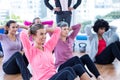 Focused women doing sit ups on hardwood floor Royalty Free Stock Photo