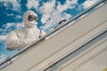 Focused worker disinfecting the handrail on the airstairs Royalty Free Stock Photo