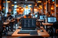 laptop displaying code with headphones on a desk in a modern office setting, illuminated by warm lighting and a blurred background Royalty Free Stock Photo