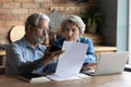 Focused worried older spouses reading financial documents checking bills Royalty Free Stock Photo