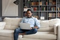 Focused young african american businessman working remotely online.