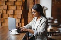 Focused young african american businesswoman or student looking at laptop, serious black woman working or studying with computer Royalty Free Stock Photo