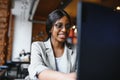 Focused young african american businesswoman or student looking at laptop, serious black woman working or studying with computer Royalty Free Stock Photo