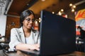 Focused young african american businesswoman or student looking at laptop, serious black woman working or studying with computer Royalty Free Stock Photo