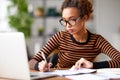 Young afro american woman working remotely or studying online at home Royalty Free Stock Photo