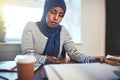 Focused young Arabic entrepreneur working in her office at home Royalty Free Stock Photo