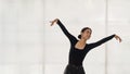 Young Asian ballet dancer practicing in a bright studio