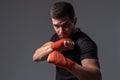 Focused young boxer with hand wraps working out defensive stance Royalty Free Stock Photo