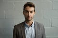 Focused young businessman standing in front of a brick wall Royalty Free Stock Photo