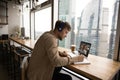 Young Caucasian man study distant on laptop