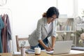 Focused young designer working standing at table.