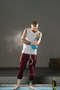 Focused young disabled armless man training in the gym, applying talcum powder Royalty Free Stock Photo