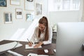 Young female architect sketching designs at her desk Royalty Free Stock Photo