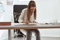 Female architect sitting at her desk working on a draft Royalty Free Stock Photo