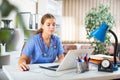 Focused young female doctor working with laptop in office Royalty Free Stock Photo