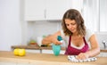 Focused young girl housewife cleaning table Royalty Free Stock Photo