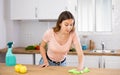 Focused young girl housewife cleaning table Royalty Free Stock Photo