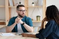 Focused young hr manager holding interview with african american applicant.