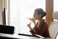 Focused young indian business woman recording audio message on cellphone. Royalty Free Stock Photo