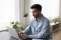 Focused young Indian professional man working on business project Royalty Free Stock Photo