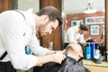 Focused Barber Trimming Client`s Facial Hair In Salon