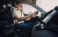 Focused young man driving car confident. Teenager driver respecting the traffic rules on the ride, keeps hands on the steering