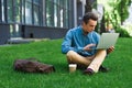 focused young man using laptop and sitting Royalty Free Stock Photo