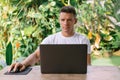Focused man using laptop, successful freelancer working online on computer sitting in modern kitchen Royalty Free Stock Photo