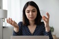 Focused young mixed race asian woman holding video call.