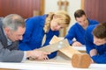 focused young people making furniture in carpenters workshop Royalty Free Stock Photo