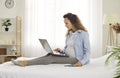 Focused young pregnant woman on maternity leave working online at home using laptop. Royalty Free Stock Photo