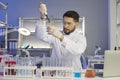 Serious young male scientist working in a pharma or biotech scientific laboratory