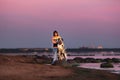 Thoughtful female owner with dog on coastline Royalty Free Stock Photo