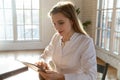 Focused young woman doctor working on tablet online in office Royalty Free Stock Photo