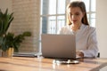 Focused young woman doctor working on laptop online in office Royalty Free Stock Photo