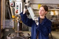 Woman drilling steel structures on drill press