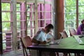 Focused young woman or student making notes, using laptop, learning foreign languages Royalty Free Stock Photo