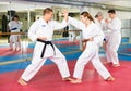 Young woman in kimono sparring with male partner during martial arts training Royalty Free Stock Photo