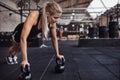 Focused young woman weight training on a gym floor Royalty Free Stock Photo