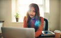 Focused young woman working online in her home office