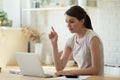 Focused young woman working online, using laptop in kitchen Royalty Free Stock Photo