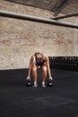 Focused young woman working out with weights in a gym Royalty Free Stock Photo