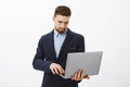 Focusing on business. Portrait of smart and ambitious concentrated good-looking young male entrepreneur with beard and Royalty Free Stock Photo