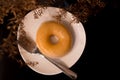 sugar donut comes with a stainless steel fork on the black table. With dried flowers as an accessory for beauty and free space for