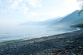 Fog on the Baikal spring sunrise stony beach Royalty Free Stock Photo