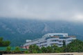 Fog comes down from the mountains to a residential building Royalty Free Stock Photo