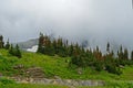 Fog covers the glaciers and mountains in Glacier National Park. Royalty Free Stock Photo