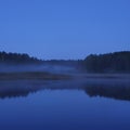 Fog creation in cold eveninig at forest lake. Karelia Royalty Free Stock Photo